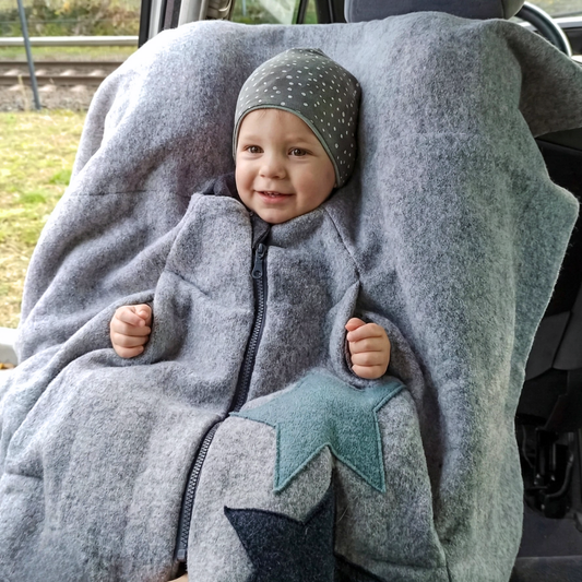 Kind im Kindersitzponcho Wollwalk – sicherer anschnallen ohne dicke Jacke - personalisierbar 